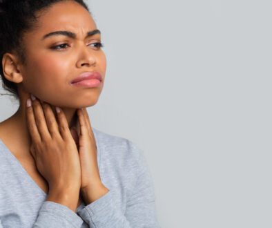 Sad Black Woman Suffering From Pain In Throat, Touching Her Neck