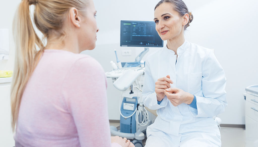 A Gynecologist Sitting In Front Of A Patient Talking To Her Does A Pap Smear Test Hurt