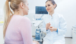 A Gynecologist Sitting In Front Of A Patient Talking To Her Does A Pap Smear Test Hurt